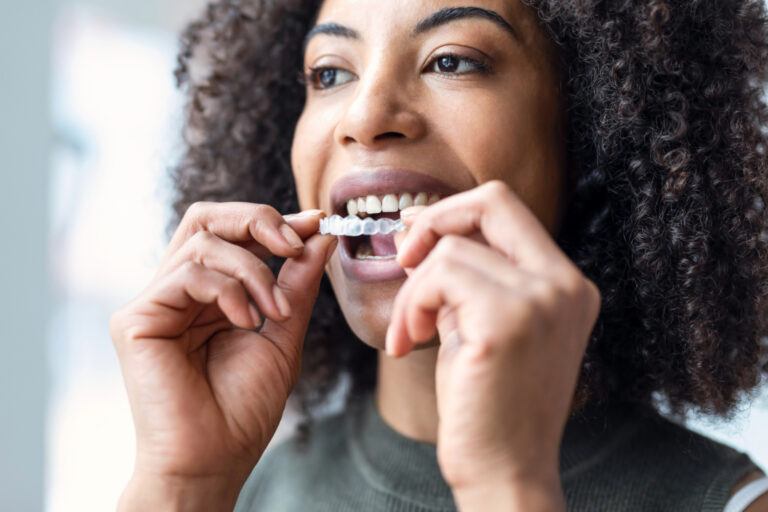Adult woman putting in a clear aligner