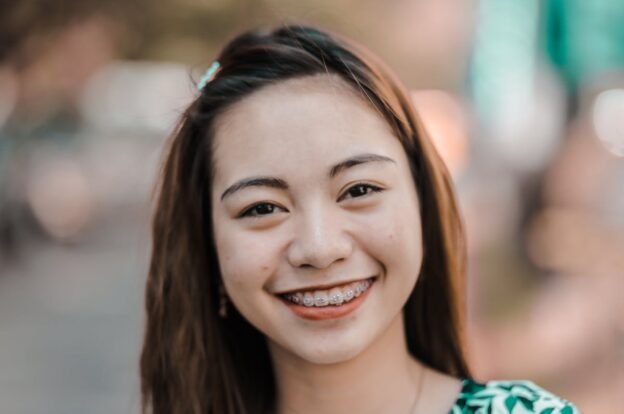 Young woman smiling with metal braces