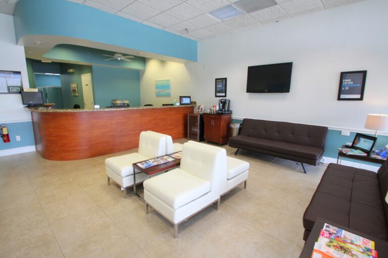 Reception desk and waiting lounge with white armchairs